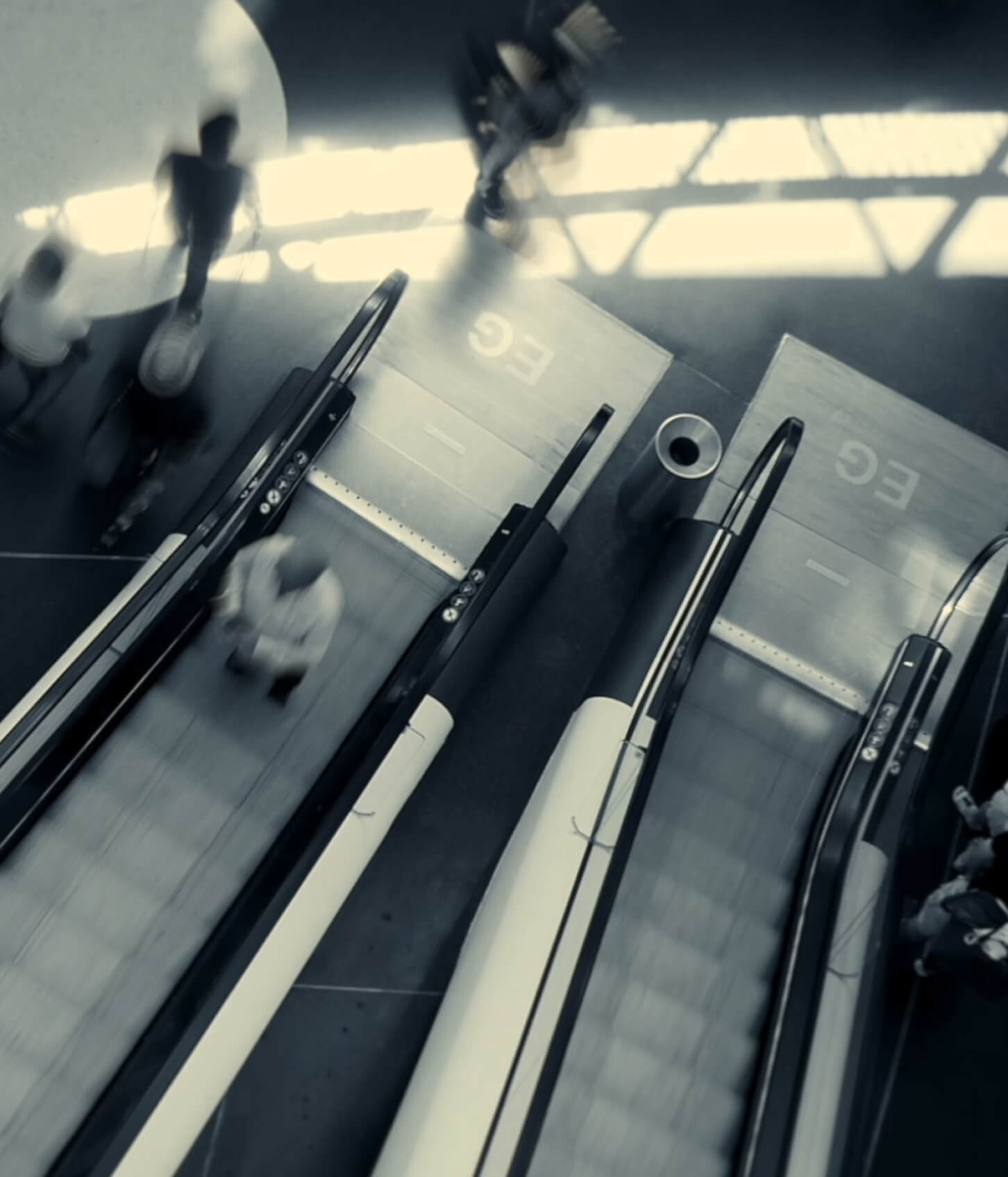 People going up the escalator from security footage
