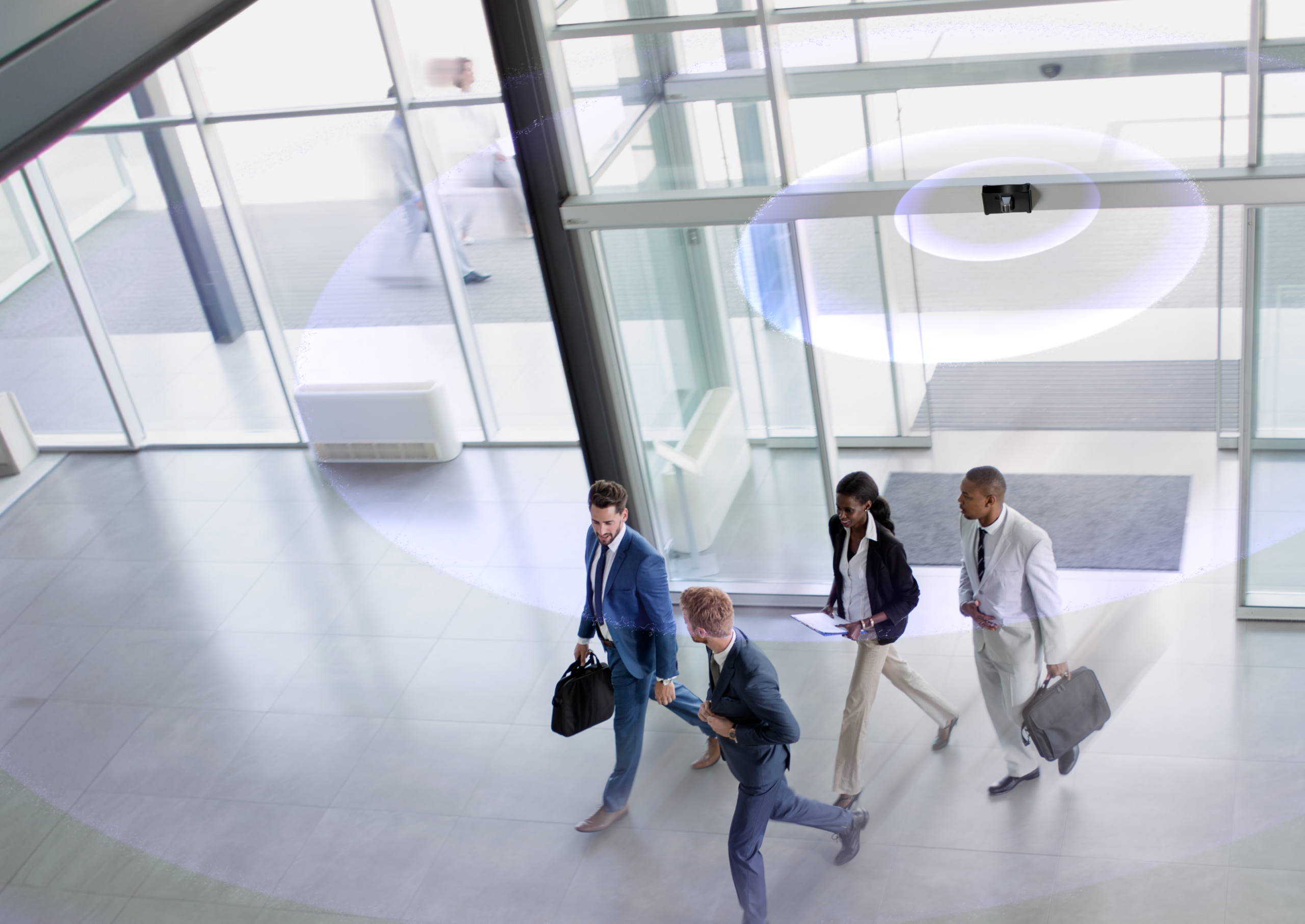 Office workers walking into building with weapon detection technology for hero